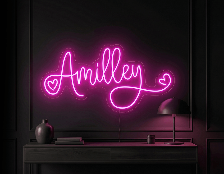 Pink custom neon sign reading Amilley with heart decorations on a dark wall